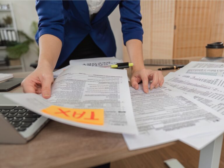 tax-preparation-and-analysis-woman-sorting-tax-documents-in-a-modern-office-environment Supreme Court’s Tax Levy Ruling Narrows Taxpayer Rights in Prepayment Challenges