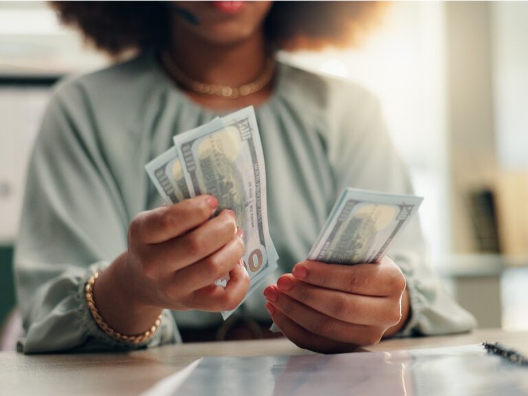business-woman-hands-or-counting-with-cash-for-finance-profit-or-salary-increase-at-office